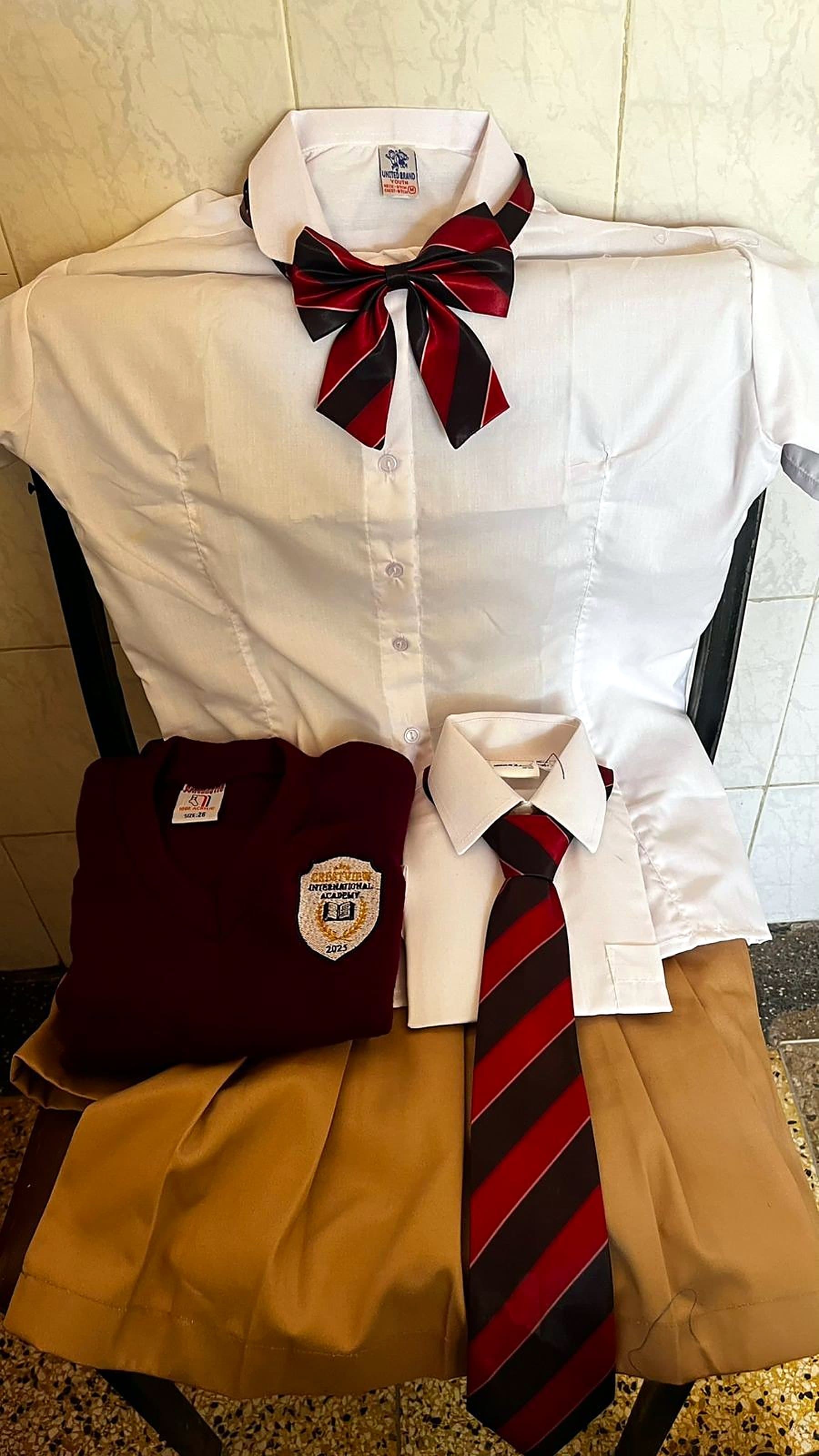 The Crestview uniform with maroon tie and crest